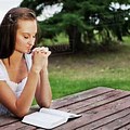 Woman Reading Bible with Snow Outside