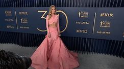 Brie Larson flaunts toned abs in pink set at 2024 SAG Awards