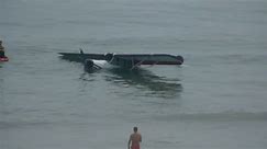 See moment plane crash lands on crowded beach