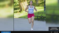 Woman running NYC marathon with inspiring message