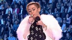 Miley accepts award, lights up