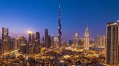 Day to night, zoom in timelapse of Burj Khalifa and other skyscrapers in Downtown Dubai, United Arab Emirates (UAE), business and finance concept, modern cities and skylines.