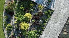Caucasian Garden Worker in His 40s Cleaning Garden Concrete Patio and Stairs Using Air Blower Aerial View