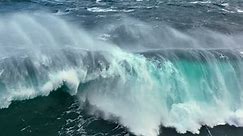 Aerial shot of powerful tsunami wave. Slow motion of big sea or ocean surf wave crashing. UHD, 4K.