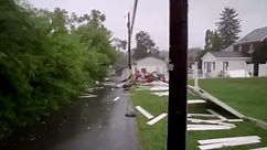 Pennsylvania resident surveys damage after storm rips through his town