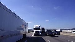 Ontario, Canada October 2016 4K POV reverse angle shot of truck and car traffic on busy highway 401