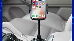 Drive smarter with this adjustable cup holder phone mount! 📱 Its extendable sidearms accommodate smartphones from 1.77 to 4.1 inches wide, ensuring a secure grip for most devices. #SmartphoneHolder #DriveSafe | Lioness Gift