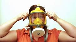 Instruction manual for use of modern gas mask or respirator. A mask used to protect the user from inhaling airborne pollutants and toxic gases. Tutorial for survival.
