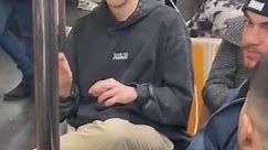 Guy using Apple Vision Pro on NYC subway.