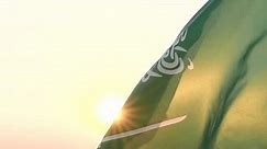 Close-up Saudi Arabia flag waving in sky against wind, beautiful sunset or sunrise outdoor backgrounds, slow motion. Concept of Saudi Arabia, Independence Day, Celebration, Holiday, Flag