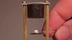 Mini Acoustic Levitator: small pieces of styrofoam become trapped between areas of higher pressure induced by high frequency sound waves. Ultrasonic transducers placed at the top and bottom are basically speakers that emit sound waves at a frequency of 43,000 Hz, which corresponds to a wavelength of 8mm for dry air. If the transducers are positioned just right standing waves are produce with nodes of low pressure at half wavelength intervals- and low mass objects like these foam pellets will be 