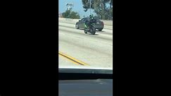 Motorcyclist Rides Sidesaddle on the Freeway