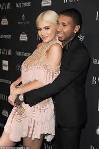 kylie jenner snuggles up to tyga as she steps out the harper s bazaar party in a daring balmain