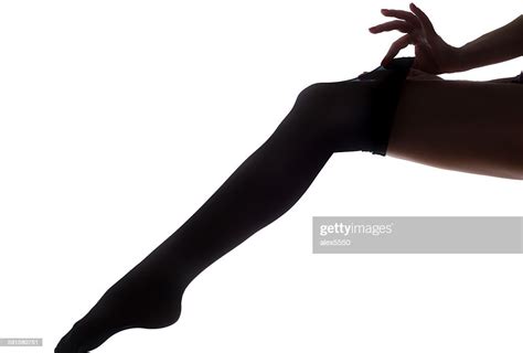 lady puts on stockings in silhouette stock foto getty images