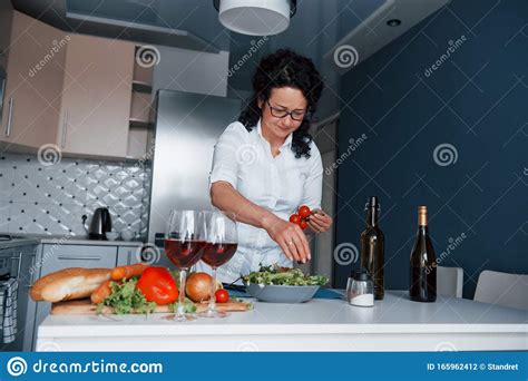 she knows what to do woman in white shirt preparing food on the