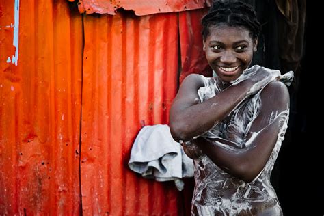 a girl having a bath dessalines port au prince haiti