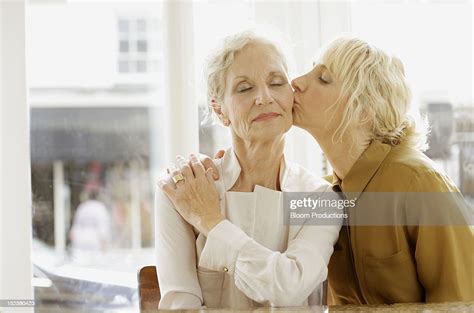 daughter kissing a mother photo getty images