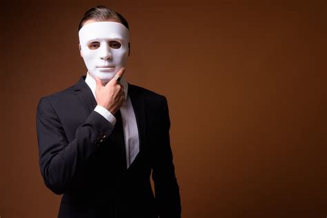 premium photo portrait  young caucasian businessman wearing white mask