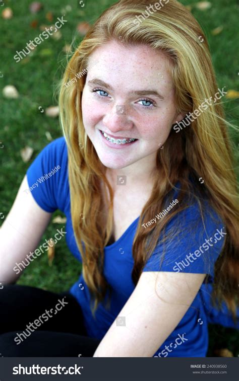pretty girl with braces freckles and long red blonde hair