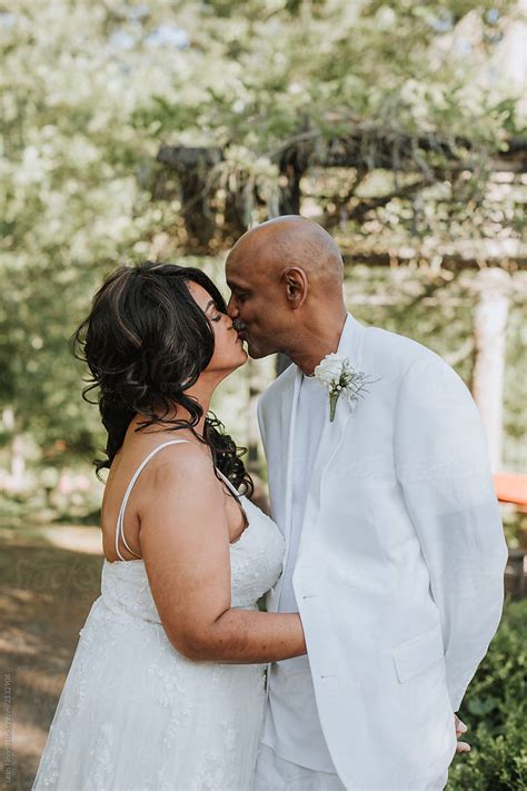 beautiful wedding couple kissing by stocksy contributor leah flores