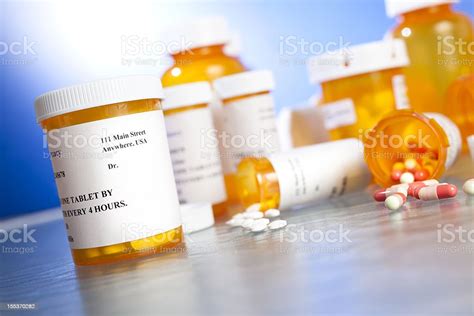 prescription drugs many pill bottles on table nobody spilling stock