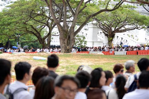 members of the public line up to pay their respects at the casket of