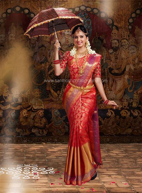woman   red  gold sari holding  umbrella