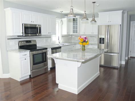 gorgeous modern kitchen  white cabinets stainless steel appliances stainless pendant