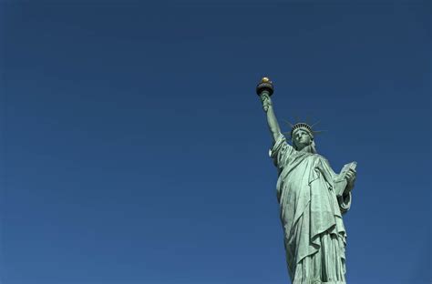 statue of liberty against clear blue sky stockfreedom