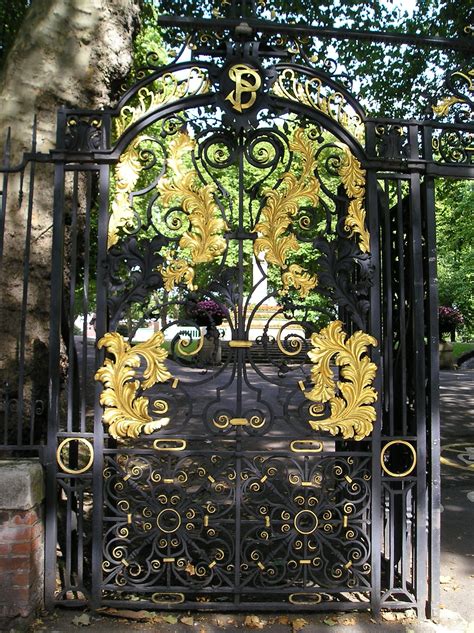 ornate iron gate  flowers  leaves   top  front   tree