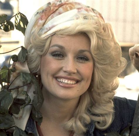 parton s over the top blonde curls form an iconic look at