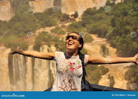 girl enjoying  amazing iguazu waterfall   argentinian side