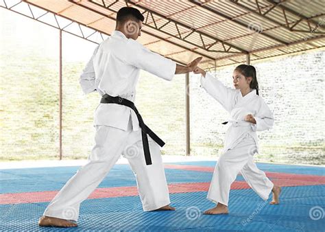 Girl Practicing Karate With Coach On Tatami Outdoors Stock Image