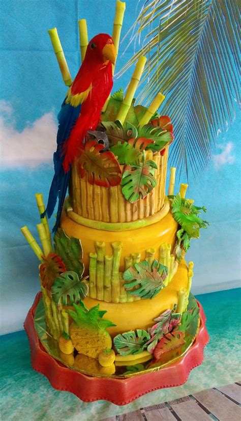 brightly colored cake   parrot sitting   top  palm trees   background