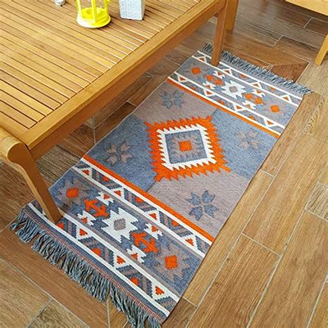 wooden table sitting  top   floor    blue  orange rug
