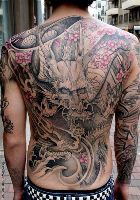 Breathtaking Massive Half Colored Asian Dragon With Flowers Tattoo On