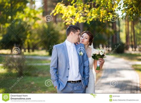 Happy Bride Groom Standing In Green Park Kissing