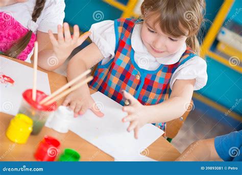 cute children painting  kindergarten stock photo image