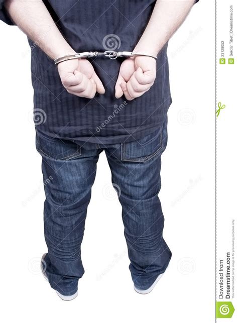 arrested businessman in handcuffs with hands behind back