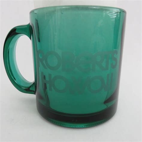 Theme The Glass Mug Is Green With The Words Roberts Hawaii Etched