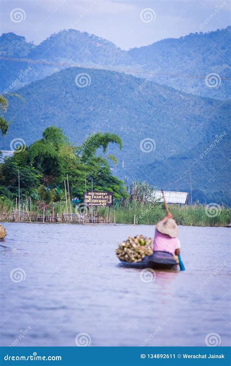 women rowing a dugout canoe in inle lake myanmar editorial photo
