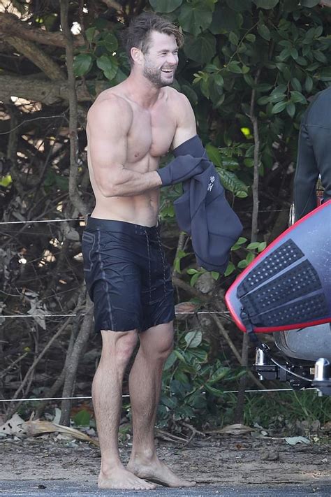 chris hemsworth displays his biceps and abs during surfing trip in