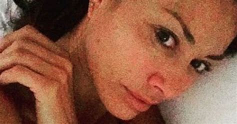 topless melanie sykes poses in just a thong and suspenders