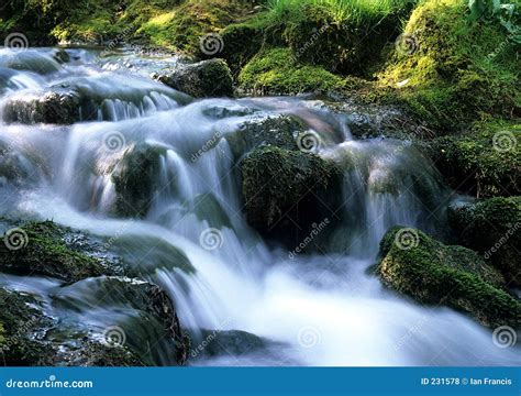 water flowing  rocks royalty  stock  image