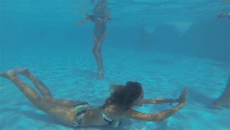 beautiful slender girls have fun and swim underwater in