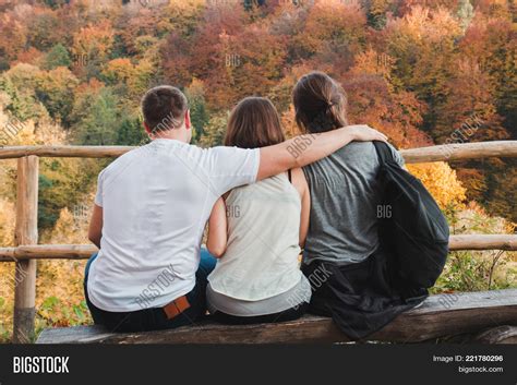 one guy hugs two girls image and photo free trial bigstock