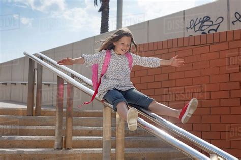 girl sliding  banister  steps stock photo dissolve