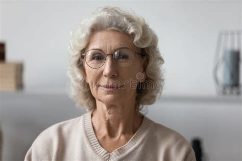 Head Shot Portrait Confident Mature Woman Wearing Glasses At Home Stock