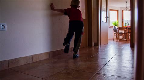 kid crashing   wall running   room  slow motion wide shot  young boy