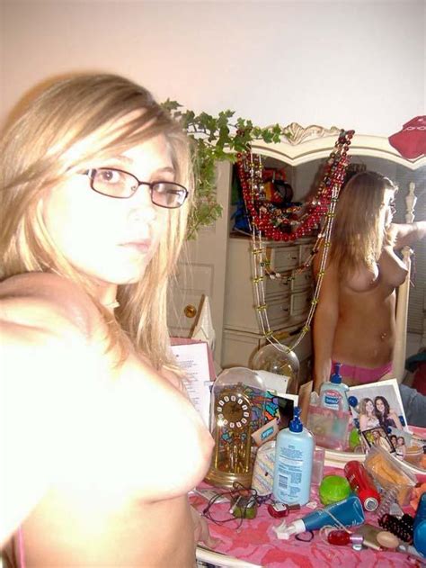 cute girl in glasses posing nude in her bedroom 9 pics